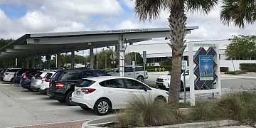 Solar energy charges electric cars at Young At Art Museum carport