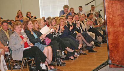 Public officials in the first row Applaud Governor Crist