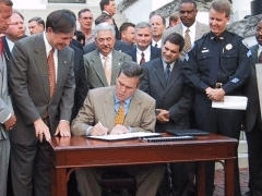 Todd Peney watches Jeb Bush sign Bryant Peney Act into law in 2001