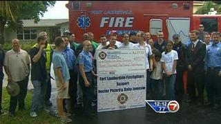 Picard Holds Check from Fort Lauderdale Firefighters