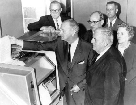 Holding a computer printout is House Speaker E.C. Rowell with Senate President James D. Connor at his side. Others shown are (l-r) J. Ed Straughn, Director of the Florida Revenue Commission; E.G. Fraiser, Secretary of the Senate; Representative George Stone, House Floor Leader; and Mrs. Lamar Bledsoe, Clerk of the House of Representatives (1965)